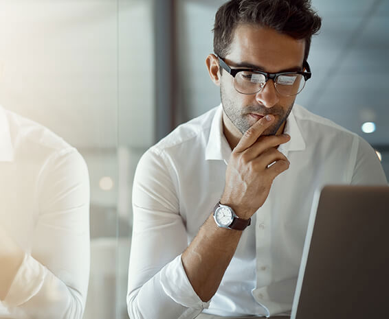 Employee sitting at his desk thinking about a career change